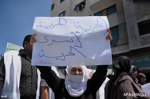 Palestinian women take part in a protest to solidarity with Palestinian prisoners in front of Red cross office in Gaza city, on June 12, 2014. 285 Palestinian prisoners are observing a mass hunger strike in protest again...