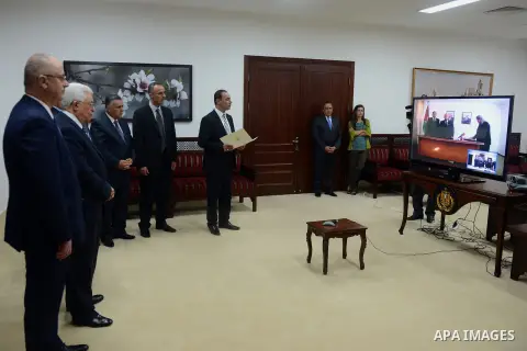 New minister of woman's Affairs in the Palestinian unity government, Haifa Al-Agha is sworn in the presence of Palestinian president Mahmud Abbas and Prime Minister Rami Hamdallah via video conference from Gaza City, in...