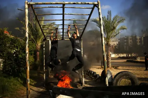 Palestinian youths take part in a military-style exercise at a summer camp organized by the Hamas movement in Gaza City June 12, 2014. Hamas stages dozens of military-style summer camps for young Palestinians in the Gaza...