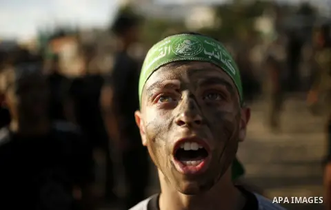 Palestinian youths take part in a military-style exercise at a summer camp organized by the Hamas movement in Gaza City June 12, 2014. Hamas stages dozens of military-style summer camps for young Palestinians in the Gaza...