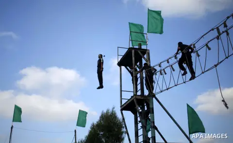 Palestinian youths take part in a military-style exercise at a summer camp organized by the Hamas movement in Gaza City June 12, 2014. Hamas stages dozens of military-style summer camps for young Palestinians in the Gaza...