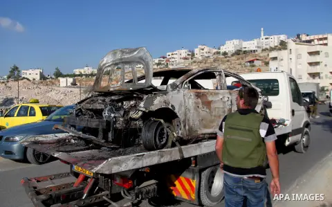 Israeli soldiers secure the area around a burnt car near the West Bank city of Hebron June 13, 2014. Israeli forces are searching for three Jewish teenagers who went missing in the occupied West Bank late Thursday, the m...