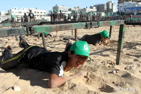 Palestinian youths take part in a military-style exercise at a summer camp organized by the Hamas movement in Gaza City June 15, 2014. Hamas stages dozens of military-style summer camps for young Palestinians in the Gaza...
