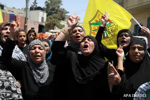 Palestinian women shoot slogans during the funeral of Ahmad Sabbarin from Jalazoun refugee camp in the West Bank near Ramallah, 16 June 2014. Sabbarin was killed by Israeli soldiers in the refugee camp on the outskirts o...