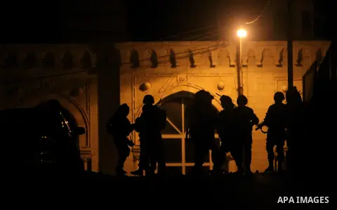 Israeli soldiers patrol the streets during an operation in the West Bank city of Ramallah on June 17, 2014 as Israeli forces broadened the search for three teenagers believed kidnapped by militants and imposed a tight cl...