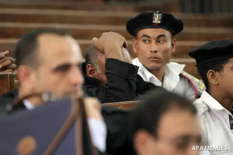 Egyptians attend the trial of Muslim Brotherhood members in the capital Cairo on June 17, 2014. The court postponed to July 23 the verdict in the trial of Muslim Brotherhood Supreme Guide Mohamed Badie and 50 others in t...