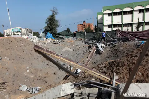 Palestinians inspect the rubble of a training camp used by Hamas after it was hit by an Israeli missile strike in Gaza City, early Thursday, June 19, 2014. The Israeli military said five rockets were fired from Hamas-con...