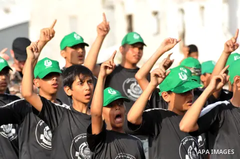 Palestinian youths take part in a graduation ceremony of a military-style summer camp organized by the Hamas movement in Gaza City June 19, 2014. Hamas stages dozens of military-style summer camps for young Palestinians...