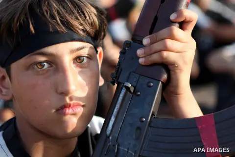Palestinian youths take part in a graduation ceremony of a military-style summer camp organized by the Hamas movement in Gaza City June 19, 2014. Hamas stages dozens of military-style summer camps for young Palestinians...