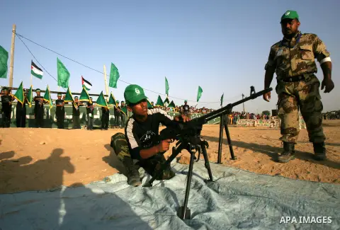 A Palestinian youth demonstrates his skills during a graduation ceremony of a military-style summer camp organized by the Hamas movement in Rafah in the southern Gaza Strip June 19, 2014. Hamas stages dozens of military-...
