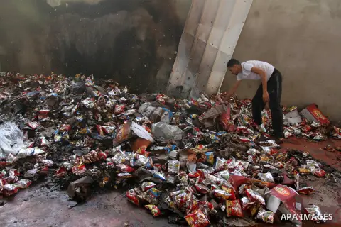 A Palestinian man inspects a food store following an Israeli air-strike in Gaza City on June 20, 2014. The Israeli army’s air force has conducted several air raids on the besieged Gaza Strip, leaving at least seven Pales...