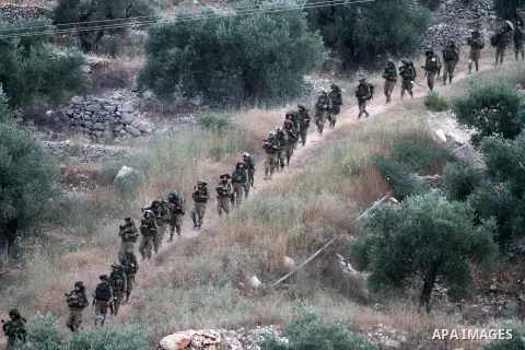 Israeli soldiers patrol on the West Bank village of Aroura near Ramallah, early on June 20, 2014. Israeli authorities have arrested about 300 activists, including 200 members of Hamas, and raided several hundred building...