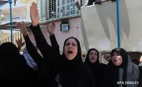 Relatives of Palestinian Ahmed Ayad, mourn during his funeral in Gaza city, on June 21, 2014. Hamas's armed wing in Gaza said at least six members of its group, were killed in the collapse of a tunnel the group had dug c...