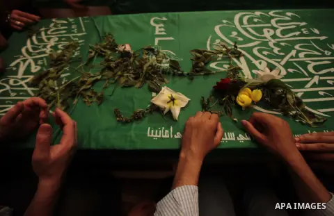 Mourners surround the bodies of Palestinian members of Hamas' armed wing during their funeral at a mosque in Gaza City June 21, 2014. Hamas' armed wing in Gaza said at least six members of its group were killed in the co...