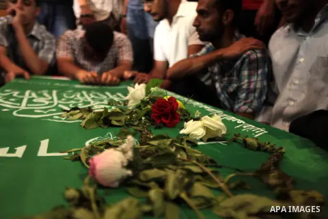 Mourners surround the bodies of Palestinian members of Hamas' armed wing during their funeral at a mosque in Gaza City June 21, 2014. Hamas' armed wing in Gaza said at least six members of its group were killed in the co...
