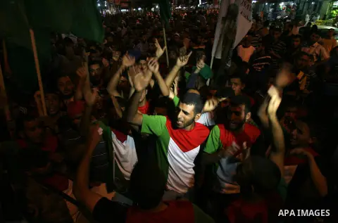 Palestinians shot slogans during a rally to express solidarity with Palestinian prisoners on hunger strike in Israeli jails, in Rafah in the souther of Gaza Strip on June 22, 2014. Israel is to rush through a bill allowi...