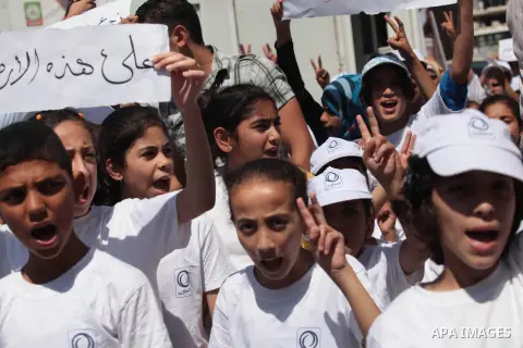 Palestinians take part in a protest in support of the Palestinian prisoners detained in Israeli jails and who have been on hunger strike for 61 days, in front of the Red cross office in Gaza City on June 23, 2014. Photo...