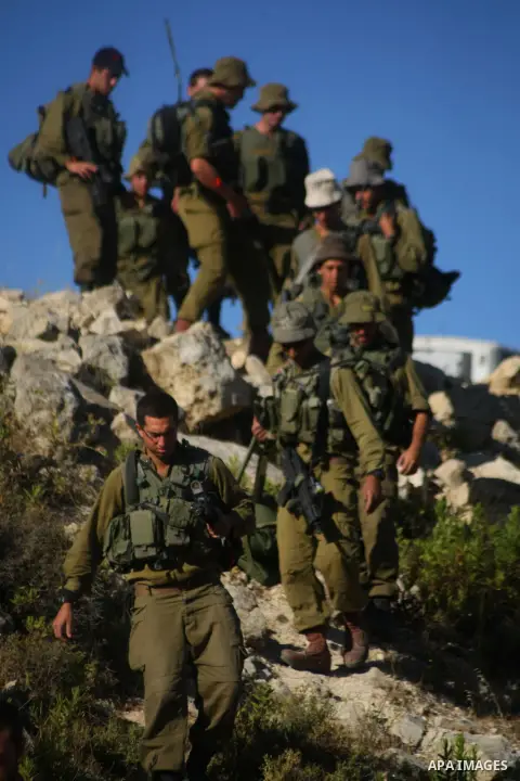Israeli soldiers search for three missing teens in the town of Halhul near the West Bank city of Hebron, Tuesday, June 24, 2014. Since launching the operation, Israel has detained at least 360 Palestinians, including 250...