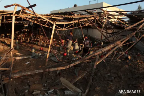 Palestinian men inspect a chicken coop damaged in an Israeli air strike in Khan Younis in the southern Gaza Strip June 25, 2014. Militants in the Gaza Strip, a coastal enclave where Hamas is dominant and has vowed reveng...