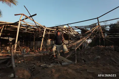 Palestinian men inspect a chicken coop damaged in an Israeli air strike in Khan Younis in the southern Gaza Strip June 25, 2014. Militants in the Gaza Strip, a coastal enclave where Hamas is dominant and has vowed reveng...