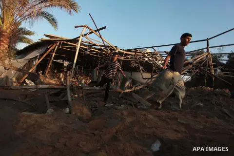 Palestinian men inspect a chicken coop damaged in an Israeli air strike in Khan Younis in the southern Gaza Strip June 25, 2014. Militants in the Gaza Strip, a coastal enclave where Hamas is dominant and has vowed reveng...