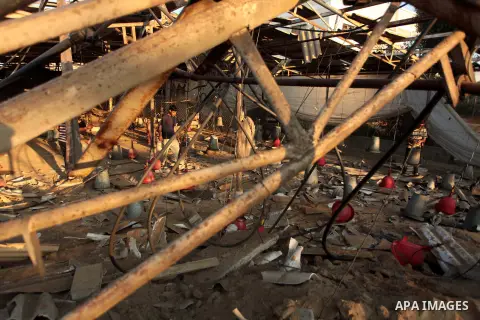 Palestinian men inspect a chicken coop damaged in an Israeli air strike in Khan Younis in the southern Gaza Strip June 25, 2014. Militants in the Gaza Strip, a coastal enclave where Hamas is dominant and has vowed reveng...