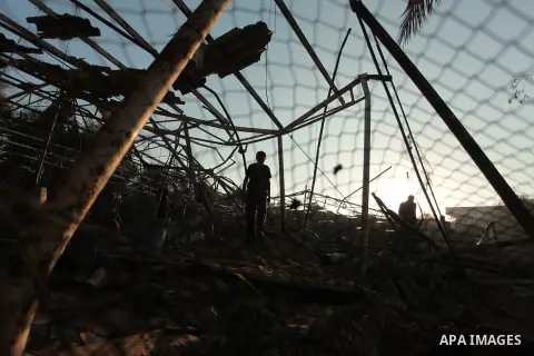 Palestinian men inspect a chicken coop damaged in an Israeli air strike in Khan Younis in the southern Gaza Strip June 25, 2014. Militants in the Gaza Strip, a coastal enclave where Hamas is dominant and has vowed reveng...