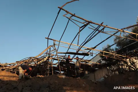 Palestinian men inspect a chicken coop damaged in an Israeli air strike in Khan Younis in the southern Gaza Strip June 25, 2014. Militants in the Gaza Strip, a coastal enclave where Hamas is dominant and has vowed reveng...