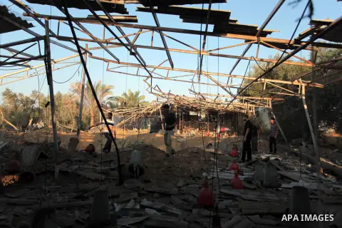 Palestinian men inspect a chicken coop damaged in an Israeli air strike in Khan Younis in the southern Gaza Strip June 25, 2014. Militants in the Gaza Strip, a coastal enclave where Hamas is dominant and has vowed reveng...