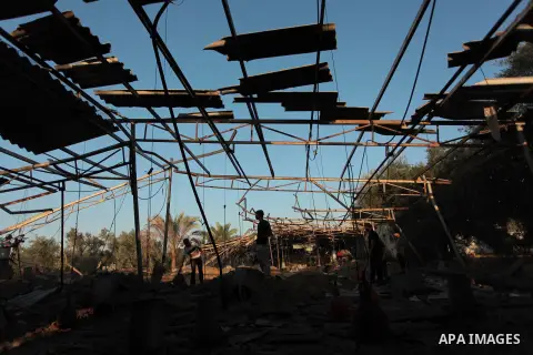 Palestinian men inspect a chicken coop damaged in an Israeli air strike in Khan Younis in the southern Gaza Strip June 25, 2014. Militants in the Gaza Strip, a coastal enclave where Hamas is dominant and has vowed reveng...