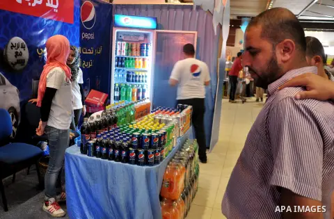 Palestinians take part in the Palestinian food exhibition, organized by the general union of Palestinian industries, in Gaza City on June 25, 2014. Photo by Mohammed Talatene