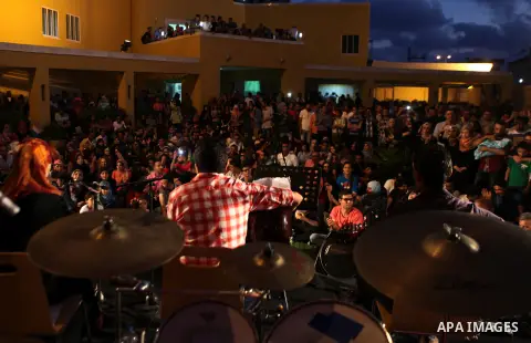 Palestinians take part in a concert in the courtyard of the French Cultural Center in Gaza City, on June 24, 2014. Photo by Ezz Zanoun