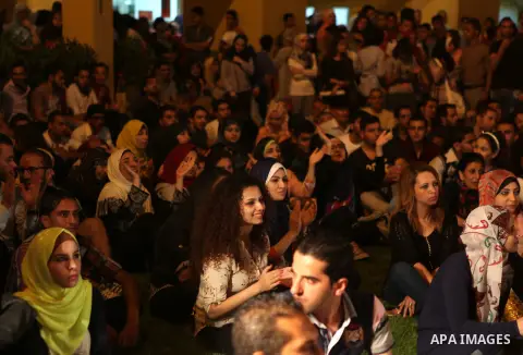 Palestinians take part in a concert in the courtyard of the French Cultural Center in Gaza City, on June 24, 2014. Photo by Ezz Zanoun