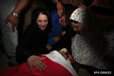 Relatives of Mostafa Aslan, 24 gather to bid farewell to his body during his funeral in the West Bank city of Ramallah on June 25, 2014. was pronounced dead from wounds he sustained during clashes with Israeli soldiers i...