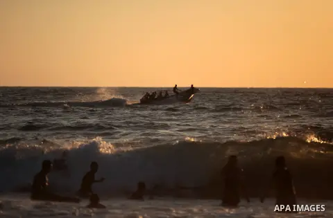 Palestinians enjoy a day on the beach in the central Gaza Strip June 26, 2014. Palestinian Environment Quality Authority said in a statement the pollution of the seawater has gone beyond 50 percent. The lack of enough fu...