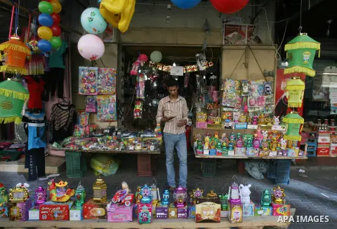 A Palestinian man sells traditional Ramadan lanterns at his a shop marking the holy month of Ramadan at a market in Rafah in the southern Gaza Strip, June 26, 2014. Muslims observe the dawn-to-dusk fasting during the hol...