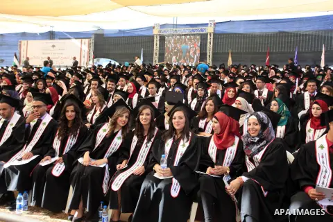 Palestinian students attend their graduation ceremony at the Birzeit University near the West Bank city of Ramallah, June 26, 2014. Photo by Issam Rimawi