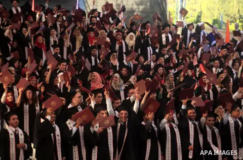 Palestinian students attend their graduation ceremony at the Birzeit University near the West Bank city of Ramallah, June 26, 2014. Photo by Issam Rimawi