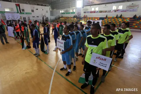 Palestinian football players participate in a match the during the championship of ''Gaza World Cup", in an event against the Israeli blockade on Gaza Strip, in Gaza City on June 27, 2014. Palestinians share a billion or...