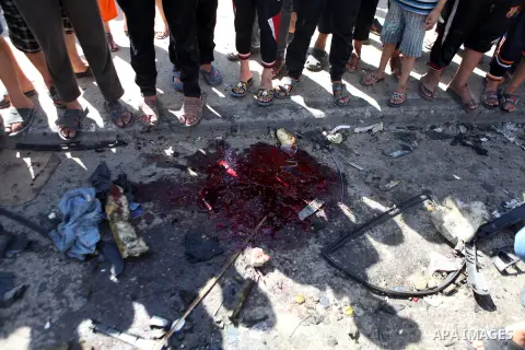Palestinians inspect the site of an Israeli air strike after targeting a car in Gaza City on June 27, 2014. The air strike killed two Palestinians, medics said, hours after a bomb exploded near troops manning Israel's se...