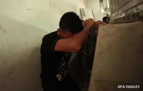 Palestinians mourn the death of two Palestinian militants outside a hospital morgue in Gaza City June 27, 2014. An Israeli air strike killed two Palestinian militants and critically wounded a third in the Gaza Strip on F...