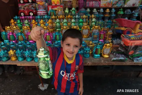 A Palestinian boy carries a traditional Ramadan lantern at a market in Gaza City, as Muslims prepare for the upcoming holy fasting month of Ramadan, on June 28, 2014. on the eve of the start of the Muslim holy month of R...