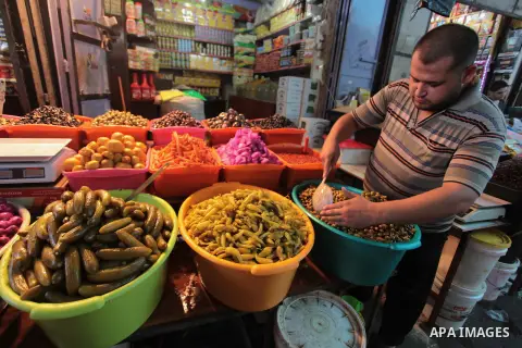 A Palestinian man sells pickles in her shop at a market in Gaza City, as Muslims prepare for the upcoming holy fasting month of Ramadan, on June 28, 2014. on the eve of the start of the Muslim holy month of Ramadan. Duri...