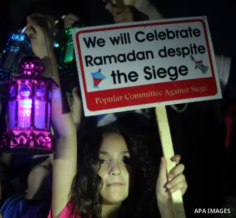 Palestinians children hold Ramadan lanterns during a night vigil in Gaza City, calling for international attention to the deteriorating economic situation in the territory. Saturday, June 28, 2014. Ramadan falls this yea...