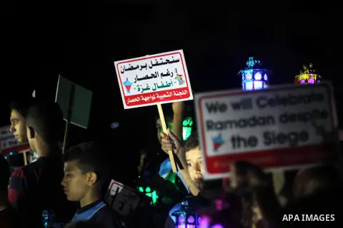 Palestinians children hold Ramadan lanterns during a night vigil in Gaza City, calling for international attention to the deteriorating economic situation in the territory. Saturday, June 28, 2014. Ramadan falls this yea...