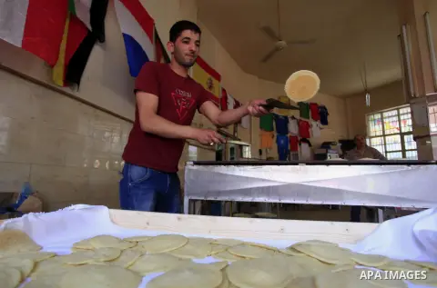 A Palestinian sweet maker prepares pancake called "katayef" on the First day of Ramadan, the holy fasting month, in the West Bank city of Ramallah on June 29, 2014. Muslim believers abstain from eating, drinking, smoking...