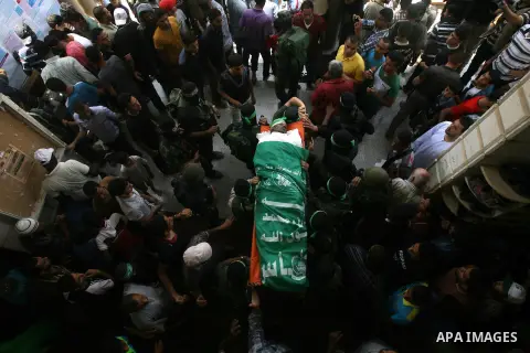 Palestinian members of Hamas' armed wing carry the body of their comrade Mohammed Ebeid during his funeral in Deir El-Balah in the central Gaza Strip June 30, 2014. Israeli forces attacked militant targets in the Gaza St...
