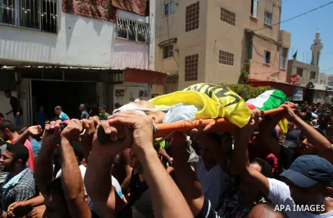 Mourners carry the body of Palestinian youth Yousef Abu Zagha, 20, during his funeral at the Jenin refugee camp, in Jenin, West Bank, 01 July 2014. Media reports citing locals and medics reports state the Israeli forces...