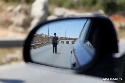 A Palestinian man walks in front of concrete barricades that blocking the road leading from Ramallah to Nablus in the West Bank, on July 01, 2014. Israeli security forces block the road near Jalazoun refugee camp earlier...