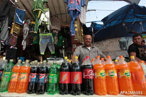 A Palestinian vendor sells soda drinks at a street market during the holy fasting month of Ramadan in Gaza city, on July 01, 2014. Muslims around the world refrain from eating, drinking and sexual intercourse from dawn t...